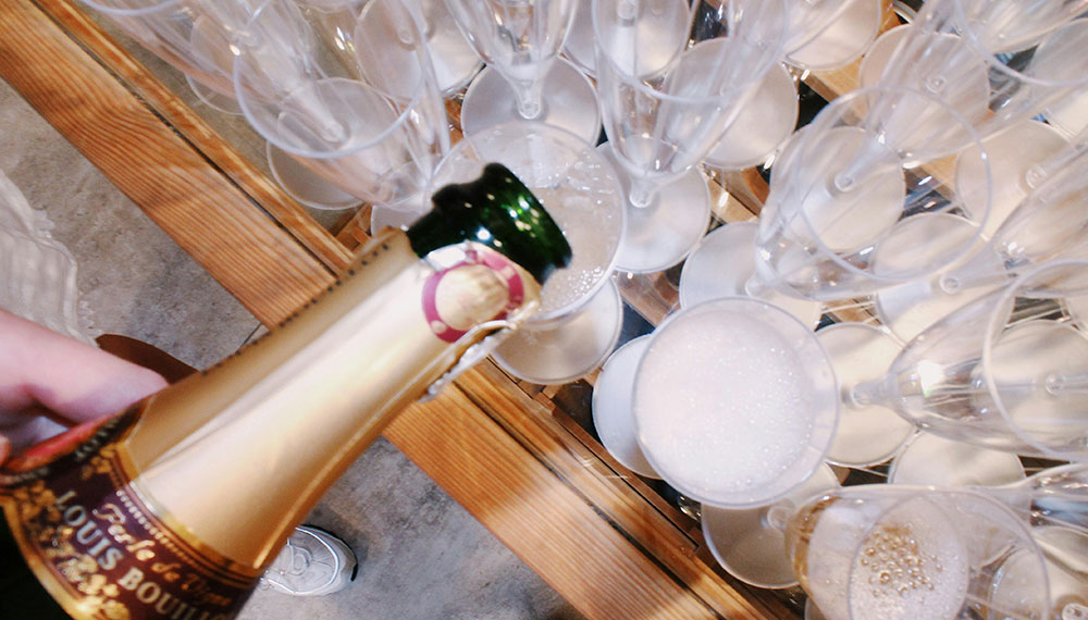 Prosecco being poured into glasses on a table