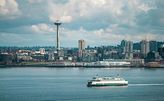 ferries in the water with Seattle skyline in the background